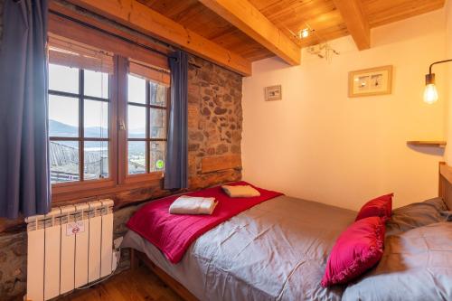 a bedroom with a bed and a window at La Grange de Cassiopée - Duplex avec vue imprenable in Les Angles