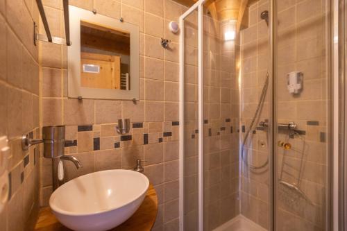 a bathroom with a sink and a shower at La Grange de Cassiopée - Duplex avec vue imprenable in Les Angles