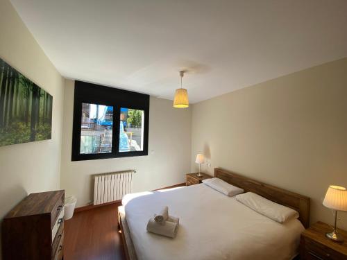 a bedroom with a white bed and a window at Canillo L'Areny View HUT - 7775 in Canillo