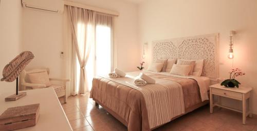 biała sypialnia z dużym łóżkiem i oknem w obiekcie Comfortable Apartment with Garden - Casa con Vista w mieście Chavania