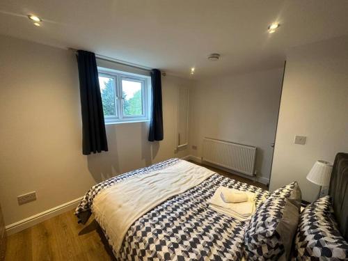 un dormitorio con una cama y una ventana en 5 bedroom House SE6, en Hither Green