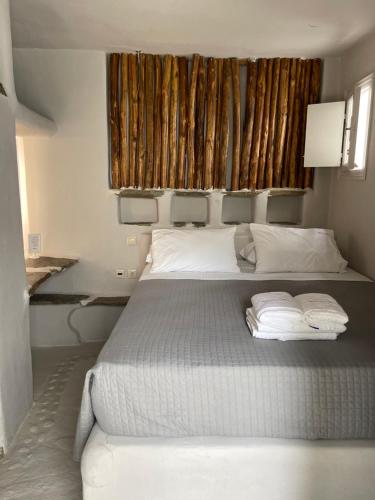 a bedroom with a bed with two towels on it at Rania Apartments Sea View in Mýkonos City