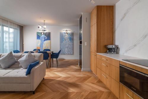 a kitchen and living room with a couch and a table at Comfort Apartments 10 lutego in Gdynia