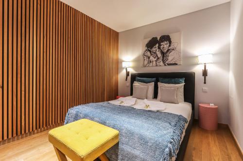 a bedroom with a bed and a table in it at Vita Portucale ! Setúbal Historical City Center in Setúbal