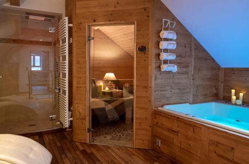 a bathroom with a blue tub in a room at La Couronne à Wissembourg in Wissembourg