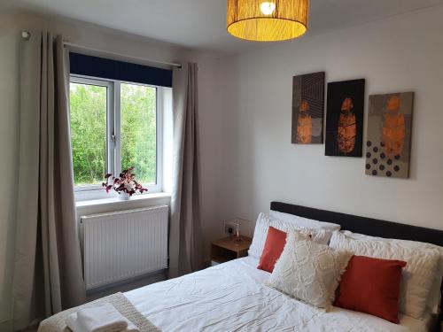 a bedroom with a bed and a window at Cozy Bedroom with Garden View in Newcastle under Lyme
