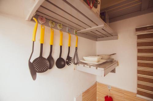 a kitchen with utensils hanging on a wall at Cozy home away from home in Lagos