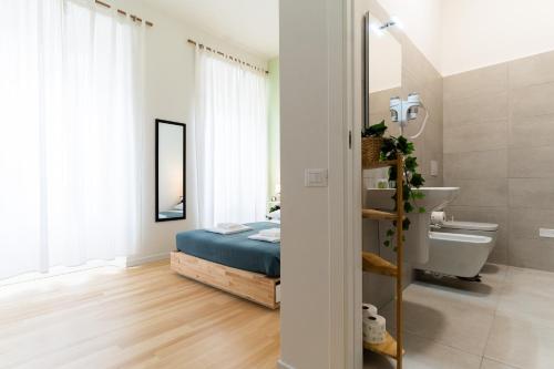 a bedroom with a bed and a bathroom with a sink at Residenza Leoncino in Verona