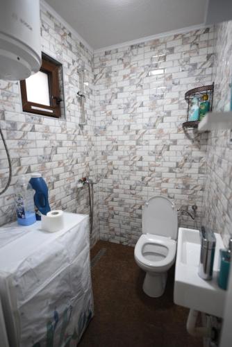 a bathroom with a white toilet and a sink at Old Town Patio House in Ohrid