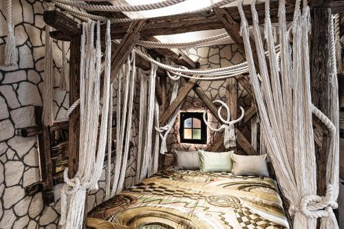 a bedroom with a canopy bed in a stone wall at Naturerlebnis Suite - Nationalpark in Ramsau