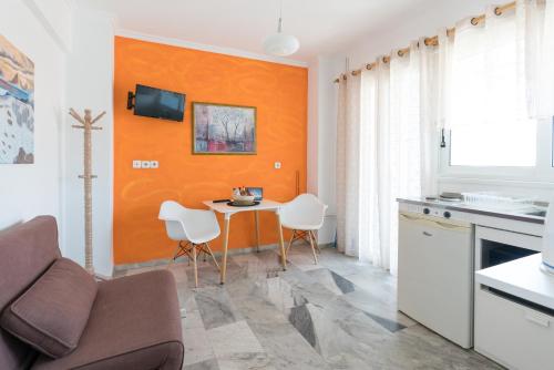 a kitchen with a table and chairs in a room at Poseidon Apartments in Skala Kefalonias
