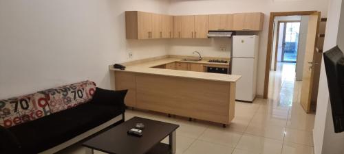 a living room with a couch and a kitchen at Le Caravelle Beirut in Beirut