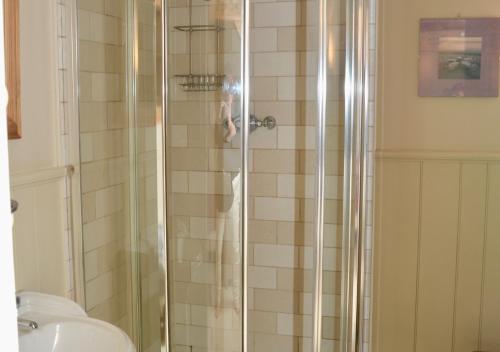 a person taking a picture of a shower in a bathroom at Coach House Cottage in Middleton