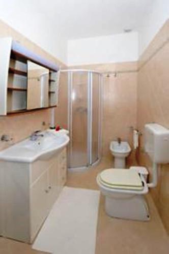 a bathroom with a toilet sink and a shower at B&B Santa Lucia in Sogliano Cavour