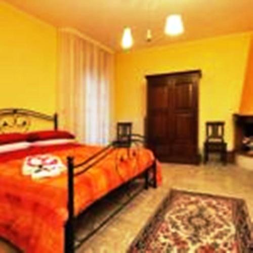 a bedroom with a large bed and yellow walls at B&B Santa Lucia in Sogliano Cavour