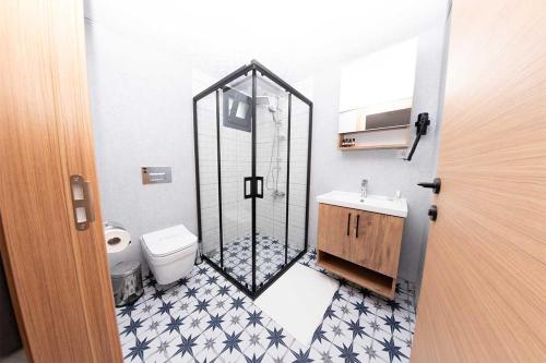 a bathroom with a shower with a toilet and a sink at Foça Kybele in Izmir