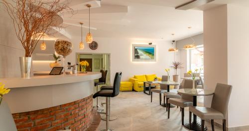 a dining room and living room with a table and chairs at Ledan in Chłopy
