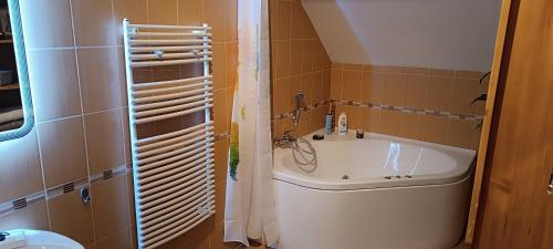 a small bathroom with a sink and a tub at Blue Home in Balatonföldvár