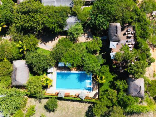 an overhead view of a swimming pool and trees at Mangal Beach Lodge in Vilanculos
