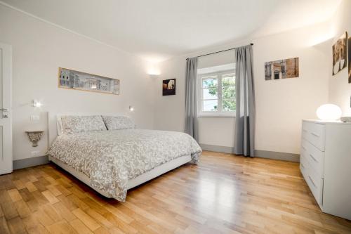 Habitación blanca con cama y ventana en Il Nido en Pienza