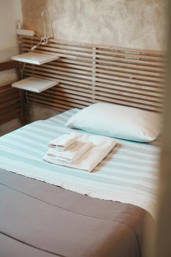 a bed with two towels sitting on top of it at Dimora Mariù in Taranto