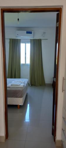 a bedroom with a bed and a large doorway at Pampa Modern Apartment in Simoca