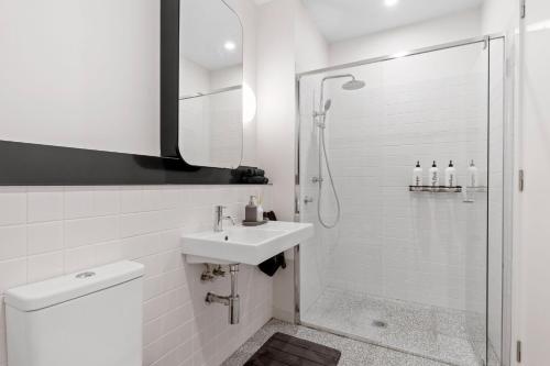 a white bathroom with a sink and a shower at Phenomenal Stay In Phillip in Phillip