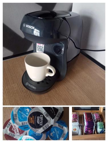 a coffee maker with a cup of coffee on a table at Wroclove Airport Loft in Wrocław