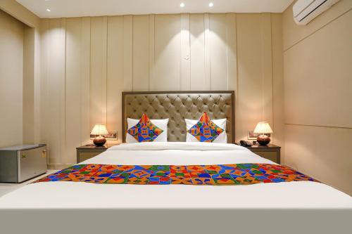 a large bed in a room with two lamps at FabHotel Infinity Stay II in Gurgaon