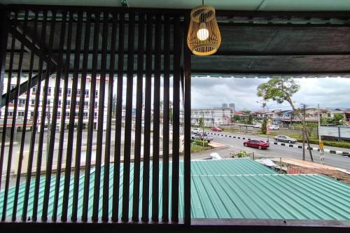 a view of a building with a green roof and a street at Nanyang Homestay 10 pax Free Wifi & Washer-1st Floor in Sibu