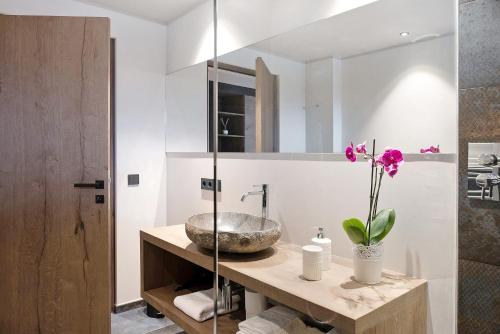 a bathroom with a sink and a mirror at Angerle Alm Apt König Laurin in Carezza al Lago