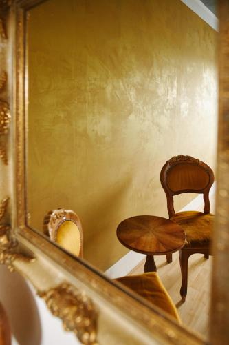 a reflection of a chair and a table in a mirror at Sleep Station Hostel in Münster