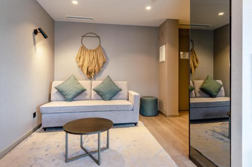 a living room with a couch and a table at OMID Saldanha Hotel in Lisbon