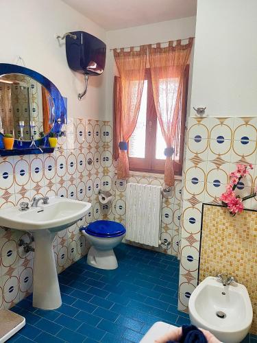a bathroom with a toilet and a sink at Villa Eden in Domusnovas