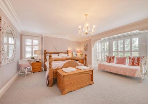 a bedroom with a bed and a couch and a table at Church Beck House in Scalby