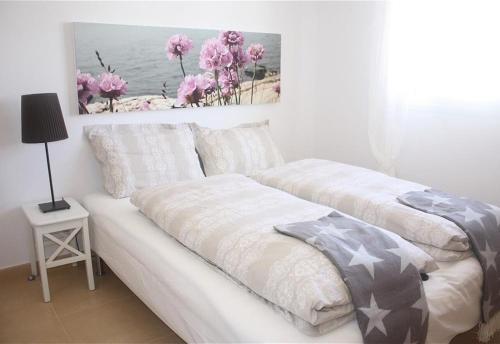 a white couch in a room with a painting on the wall at Casa la Vida - Golf villa with private pool in Alhama de Murcia