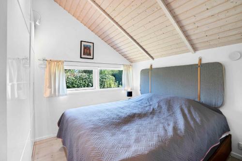 um quarto com uma cama num quarto com uma janela em Beautiful Holiday Home In North Zealand em Tikøb