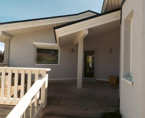 a porch of a house with a white railing at Casa Nunki in Guadalix de la Sierra