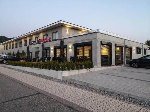 a building with a car parked in front of it at Hotel Nachtquartier in Weil der Stadt