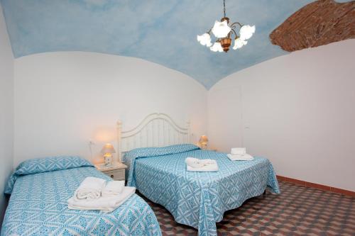 a bedroom with two beds with towels on them at Casa Irgoli - Sardegna in Irgoli