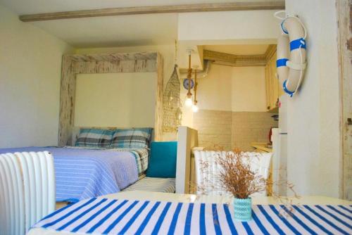 two beds in a room with blue and white stripes at Casa Mediterraneo Perast in Perast