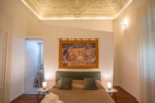 a bedroom with a bed with a painting on the ceiling at Costa Suites in Palermo