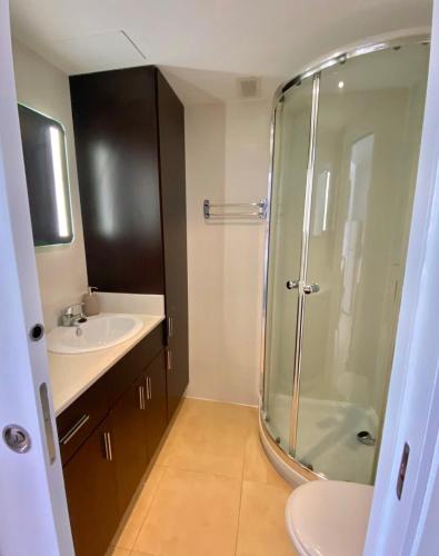 a bathroom with a shower and a sink at La Gavina Suite Xàbia in Jávea