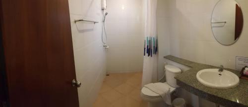 a bathroom with a shower and a toilet and a sink at Chatchada House in Ao Nang Beach