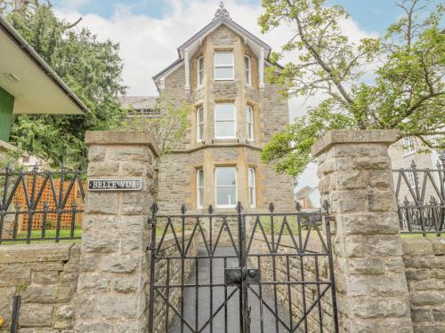 an old stone house with a gate in front of it at Belle Vue in Hereford