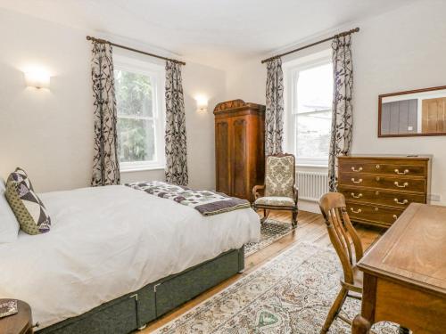 a bedroom with a bed and a desk and a chair at Belle Vue in Hereford
