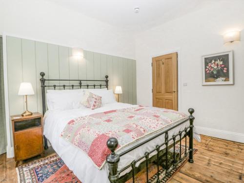 a bedroom with a large bed and a wooden floor at Belle Vue in Hereford