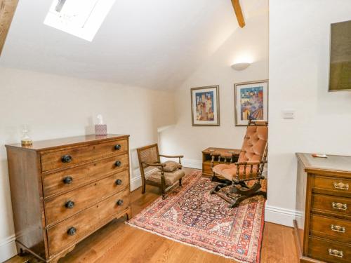 a living room with a dresser and a chair at Belle Vue in Hereford