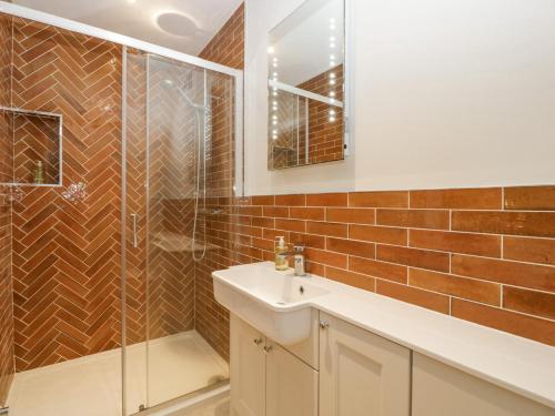 a bathroom with a sink and a glass shower at Belle Vue in Hereford