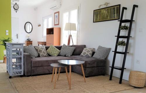 a living room with a couch and a table at Domaine de l'Envolée in Tourbes